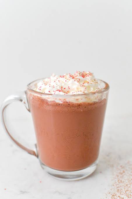 Velvet mocha bloom hot chocolate topped with whipped cream